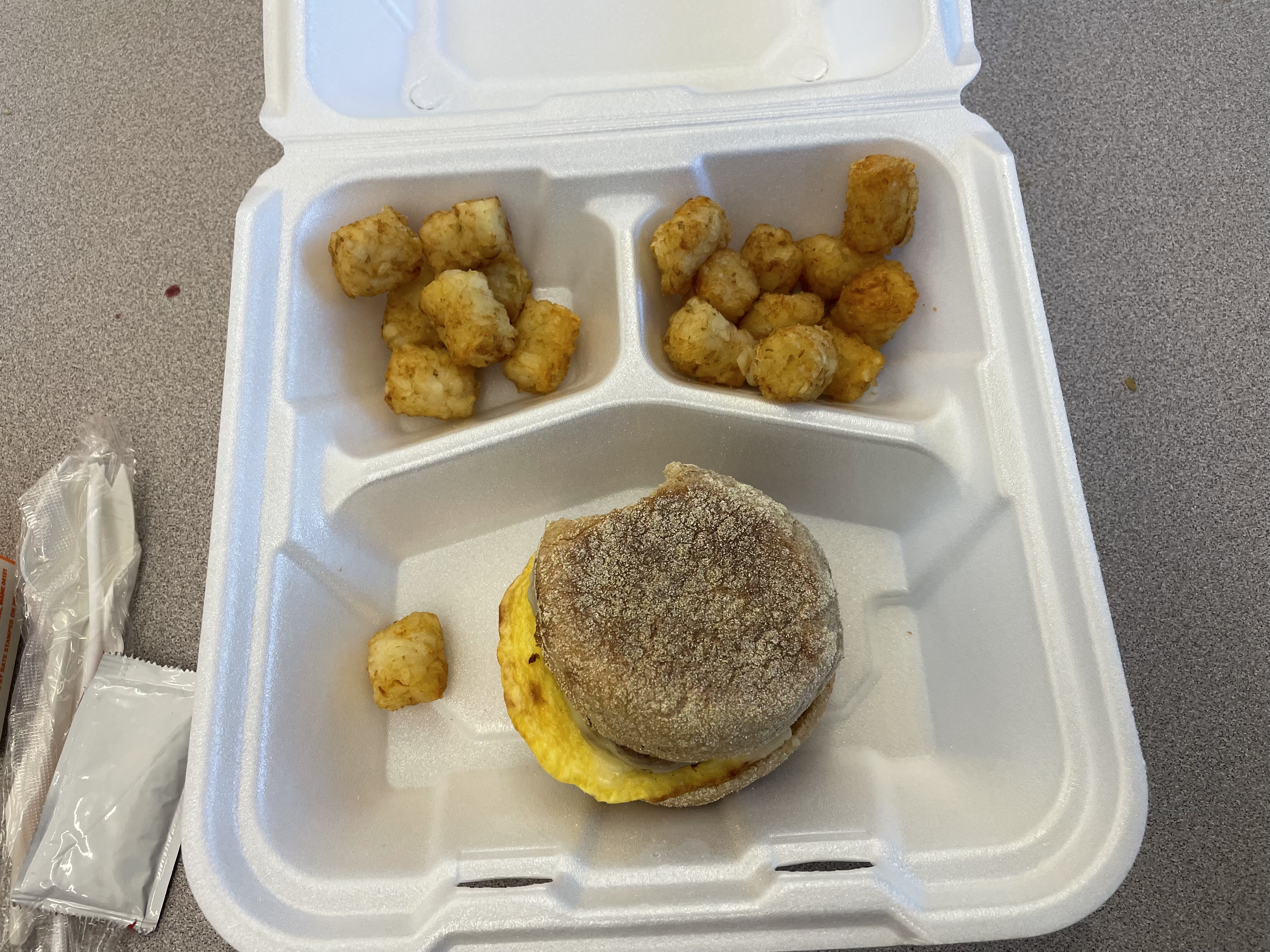 English muffin sausage egg and cheese with tator tots