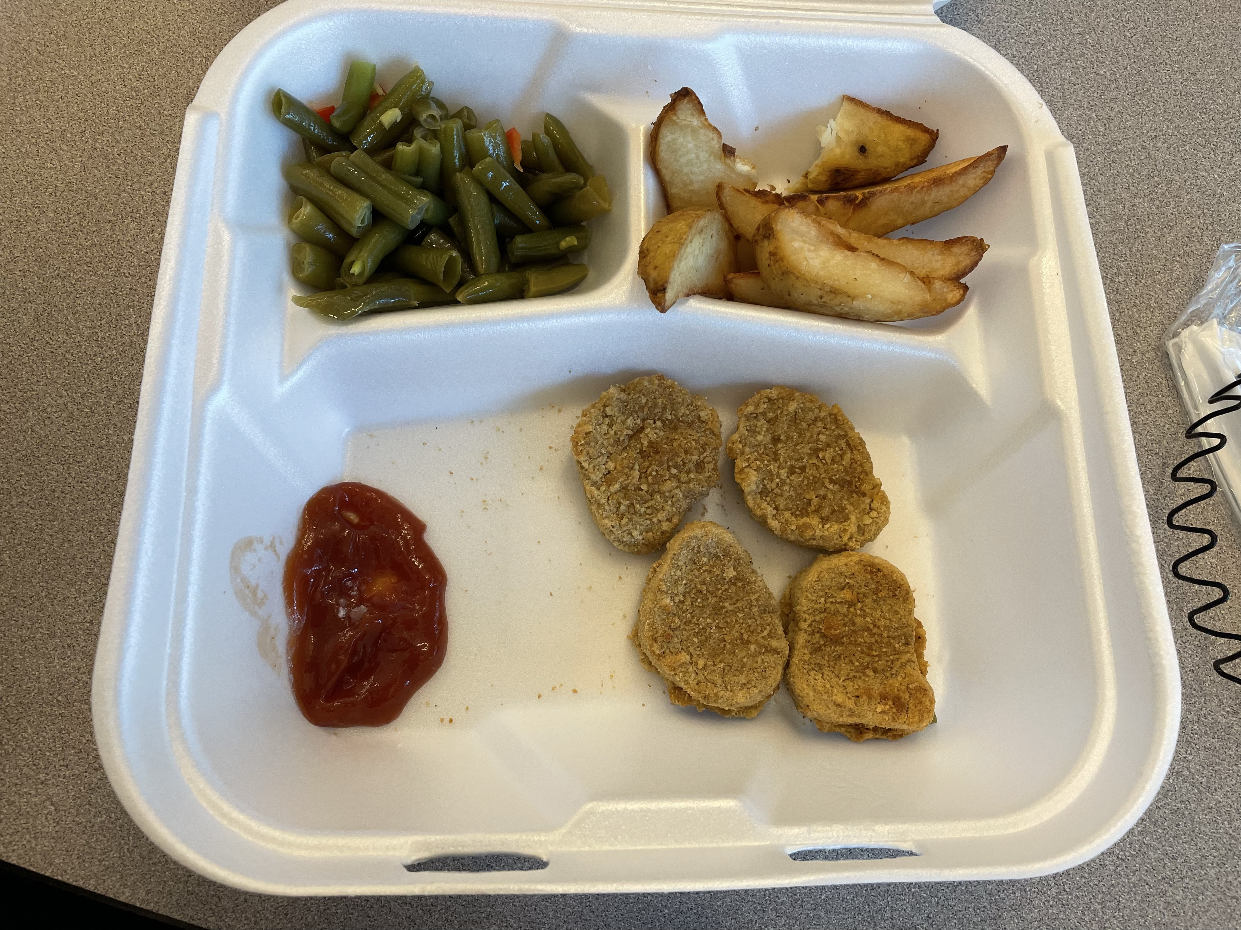 Dry chicken nuggets with some decent french fries and green beans